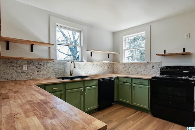 kitchen featuring butcher block countertops, plenty of natural light, sink, and black appliances