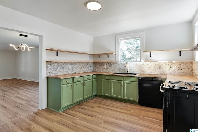 kitchen with light hardwood / wood-style floors, hanging light fixtures, black appliances, and sink