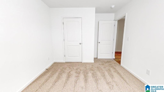 unfurnished bedroom with light carpet