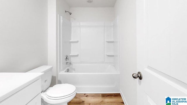 full bathroom featuring hardwood / wood-style floors, vanity, toilet, and shower / bathing tub combination