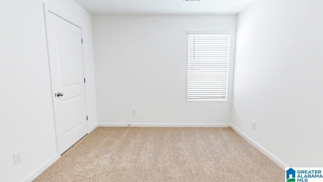 empty room featuring light colored carpet