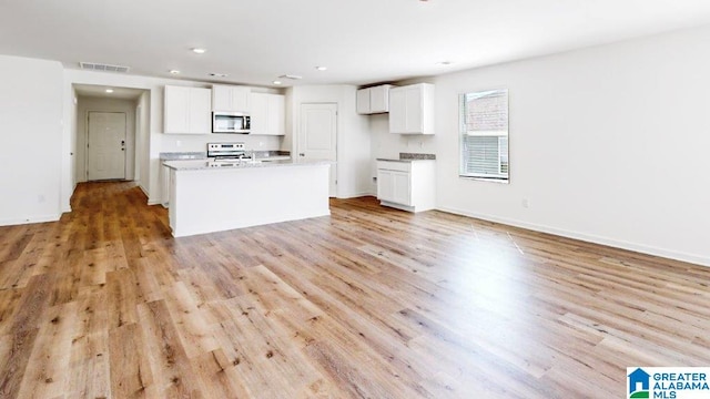 kitchen featuring white cabinets, white range, and light wood-type flooring