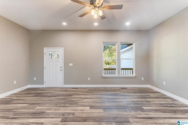 interior space featuring wood-type flooring and ceiling fan