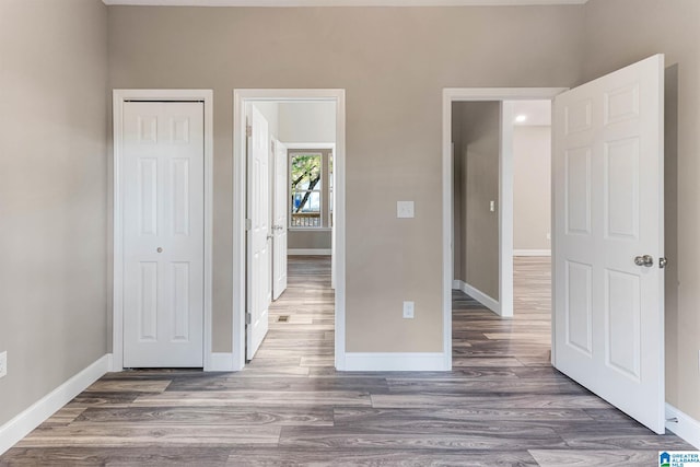 unfurnished bedroom with dark hardwood / wood-style flooring and a closet