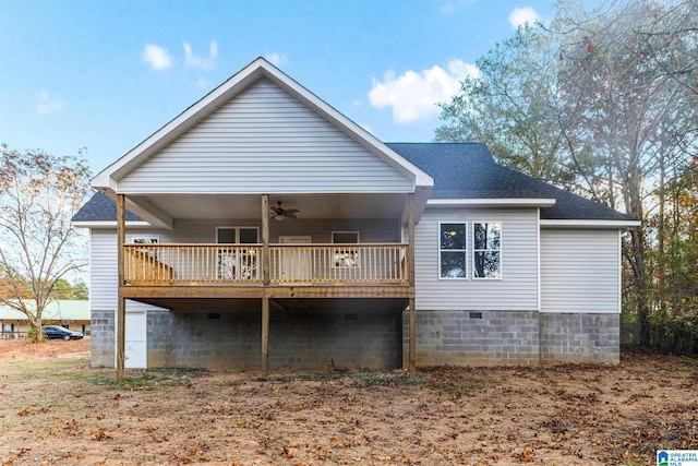 back of house featuring ceiling fan and a wooden deck