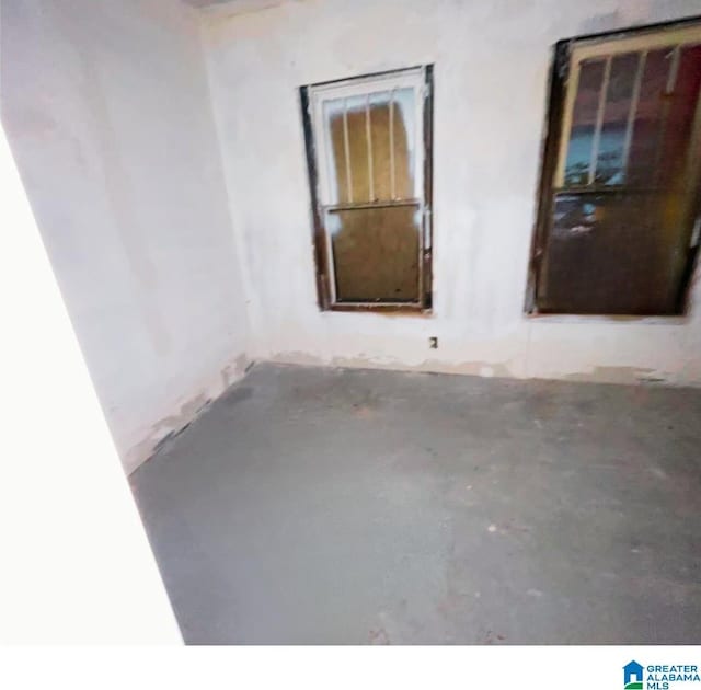 spare room with concrete flooring