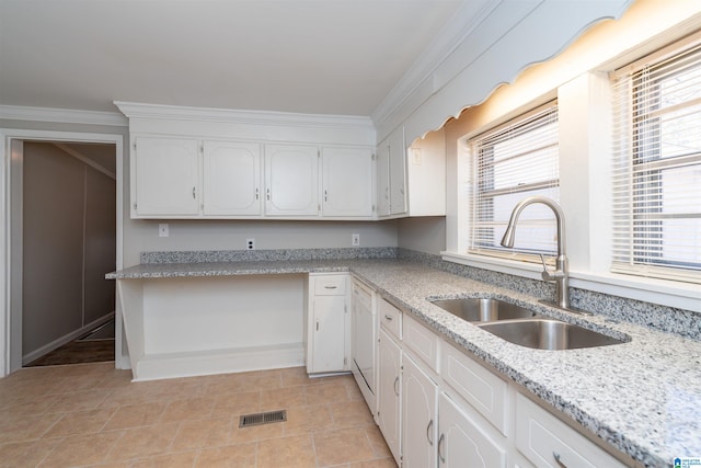 kitchen featuring white cabinetry, sink, light stone counters, and ornamental molding