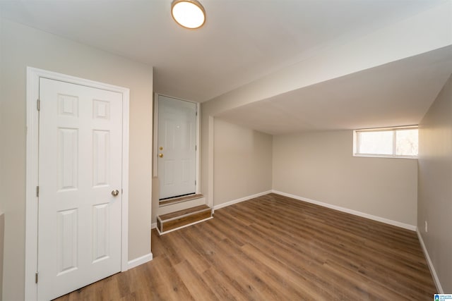 basement with dark hardwood / wood-style floors