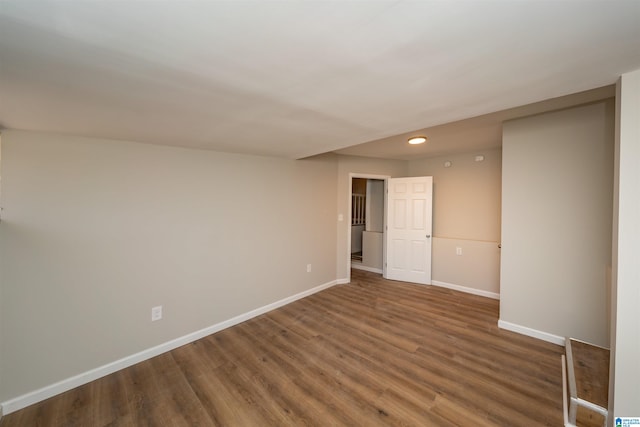 spare room featuring dark wood-type flooring