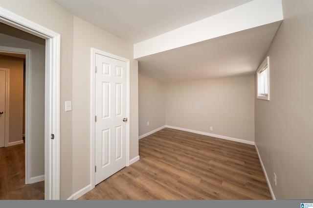 additional living space with dark hardwood / wood-style floors