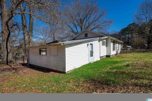 view of side of property with a lawn