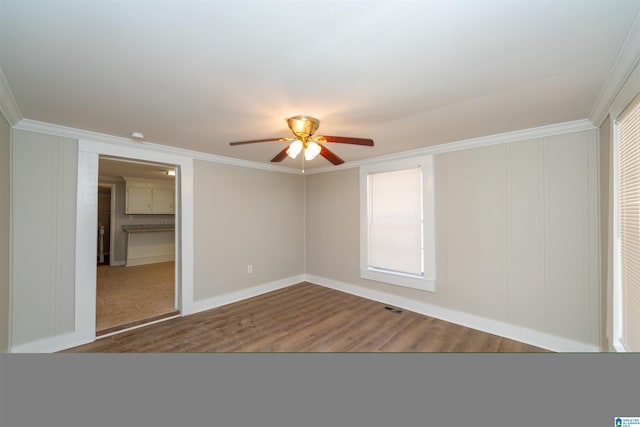 unfurnished bedroom with hardwood / wood-style floors, a closet, ceiling fan, and crown molding