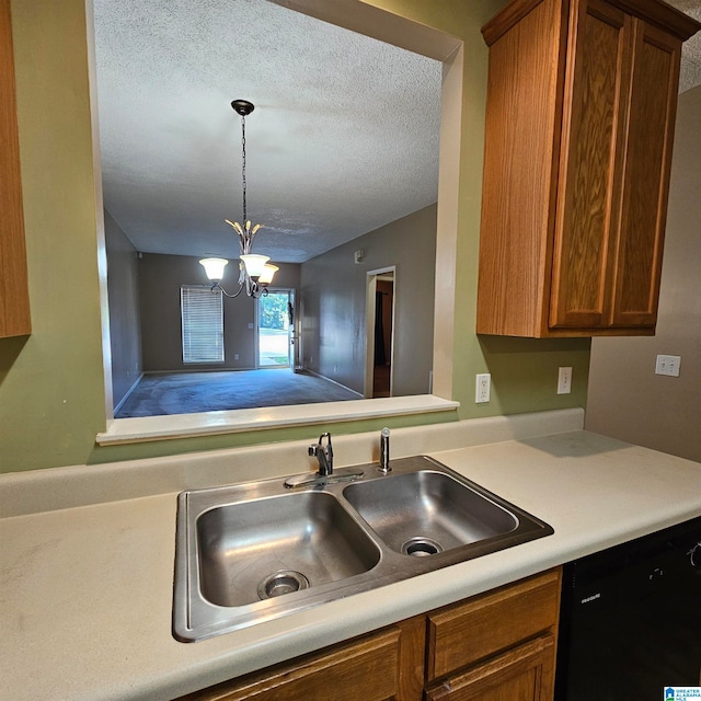 kitchen with dishwasher, sink, a textured ceiling, decorative light fixtures, and a chandelier