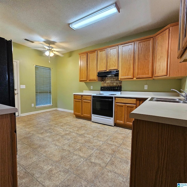 kitchen with ceiling fan, sink, white electric range oven, black fridge, and a textured ceiling