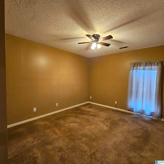 carpeted spare room featuring ceiling fan and a textured ceiling