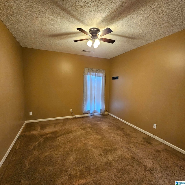 unfurnished room with carpet, ceiling fan, and a textured ceiling