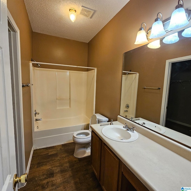 full bathroom featuring shower / bath combination, vanity, a textured ceiling, and hardwood / wood-style flooring