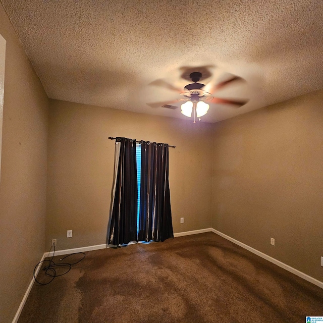 carpeted empty room with ceiling fan and a textured ceiling