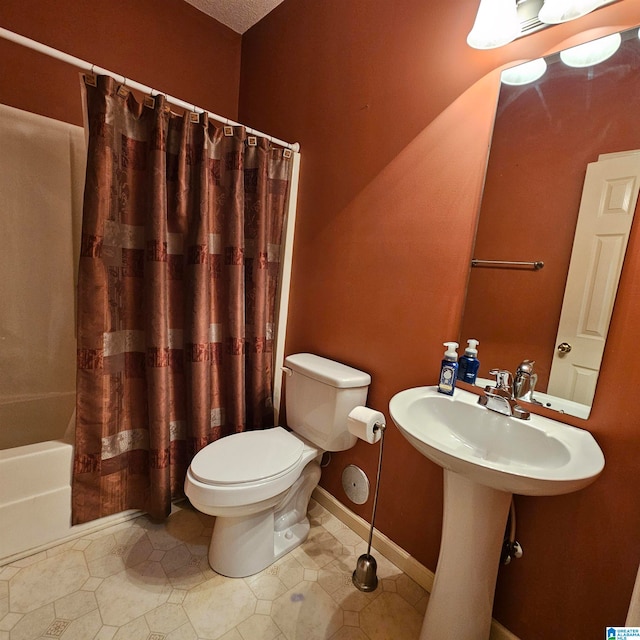 bathroom featuring tile patterned floors, toilet, and shower / tub combo with curtain