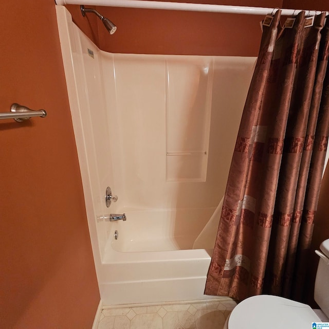 bathroom with tile patterned floors, toilet, and shower / tub combo with curtain