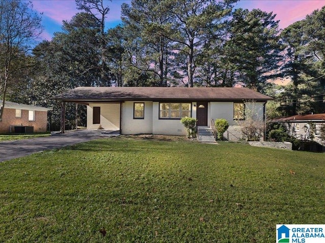 view of front of house with a yard and a carport