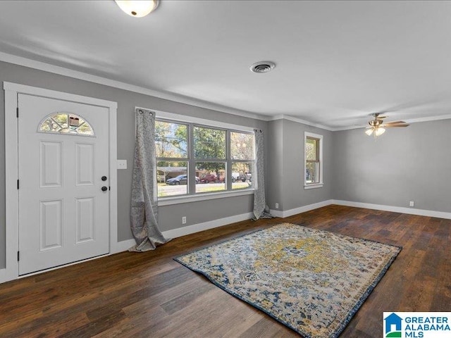 entrance foyer with ceiling fan, crown molding, and dark wood-type flooring