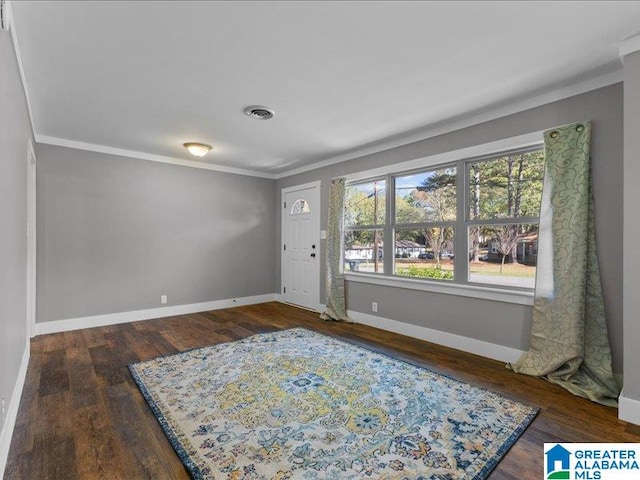 entryway with dark hardwood / wood-style floors and crown molding