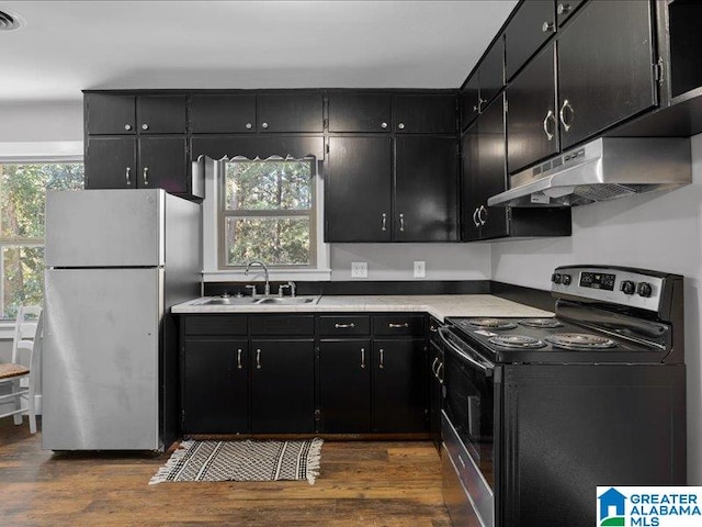 kitchen featuring appliances with stainless steel finishes, dark wood-type flooring, and sink