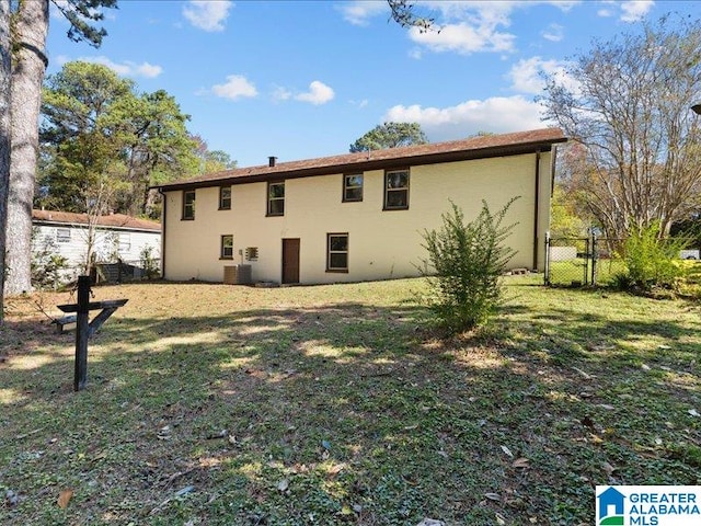 back of house with a lawn