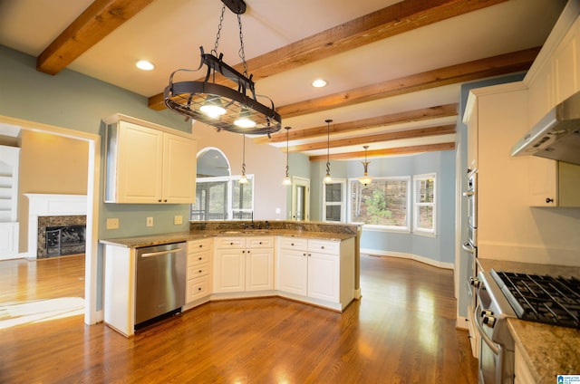 kitchen with stainless steel appliances, pendant lighting, beam ceiling, hardwood / wood-style flooring, and white cabinets