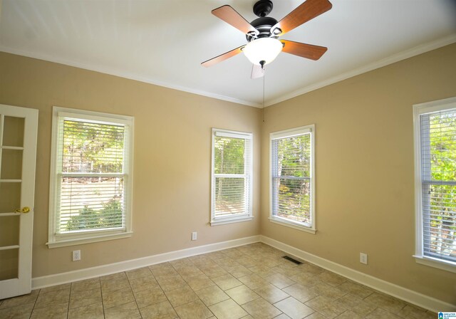 tiled spare room with ceiling fan and crown molding