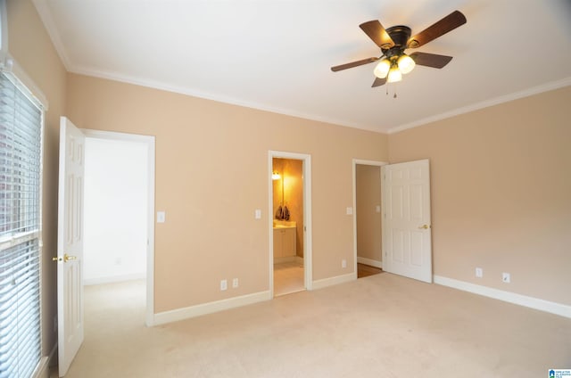 unfurnished bedroom with ensuite bathroom, ceiling fan, crown molding, and light carpet