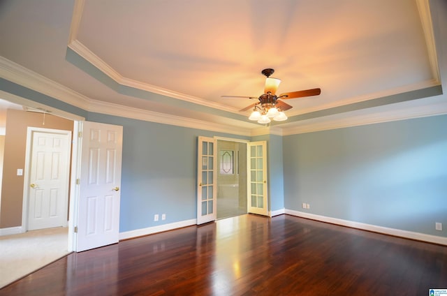 spare room featuring french doors, a raised ceiling, ceiling fan, crown molding, and dark hardwood / wood-style floors