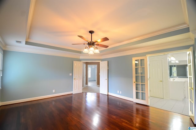 spare room with hardwood / wood-style floors, ceiling fan, a raised ceiling, and ornamental molding