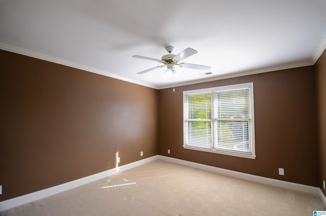 carpeted empty room featuring ceiling fan and ornamental molding