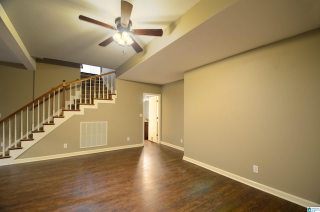 unfurnished living room with ceiling fan and dark wood-type flooring