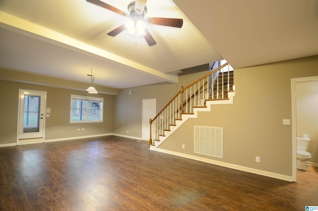 unfurnished living room featuring ceiling fan and dark wood-type flooring