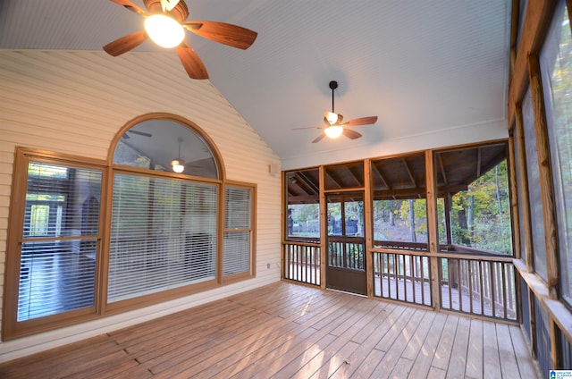 unfurnished sunroom featuring ceiling fan and lofted ceiling