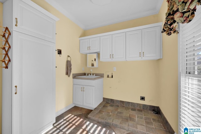 laundry area featuring electric dryer hookup, cabinets, sink, hookup for a washing machine, and ornamental molding