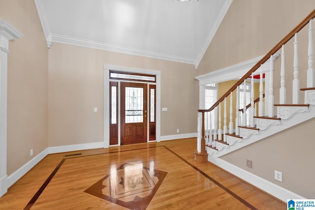 foyer with wood-type flooring and crown molding