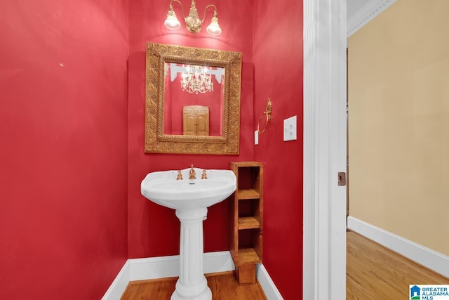 bathroom featuring hardwood / wood-style flooring and ornate columns