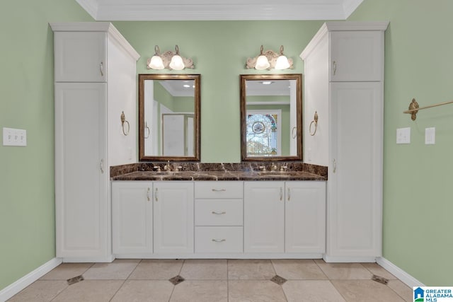 bathroom featuring tile patterned flooring, vanity, and ornamental molding