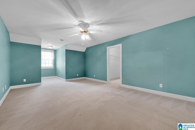 unfurnished room with light carpet and ceiling fan