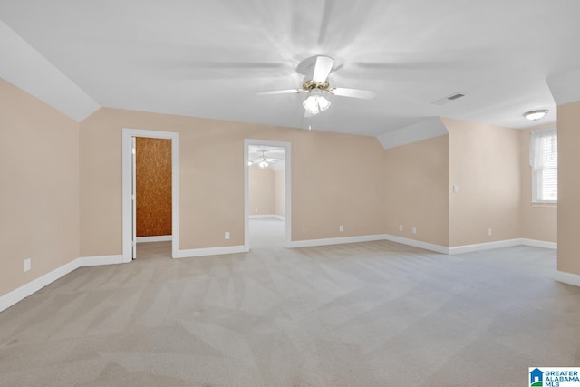 carpeted empty room with ceiling fan and vaulted ceiling