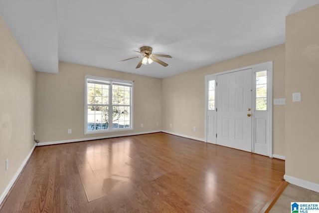 foyer entrance featuring ceiling fan, a healthy amount of sunlight, and hardwood / wood-style flooring