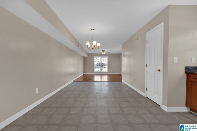 unfurnished dining area featuring ceiling fan with notable chandelier and light hardwood / wood-style floors