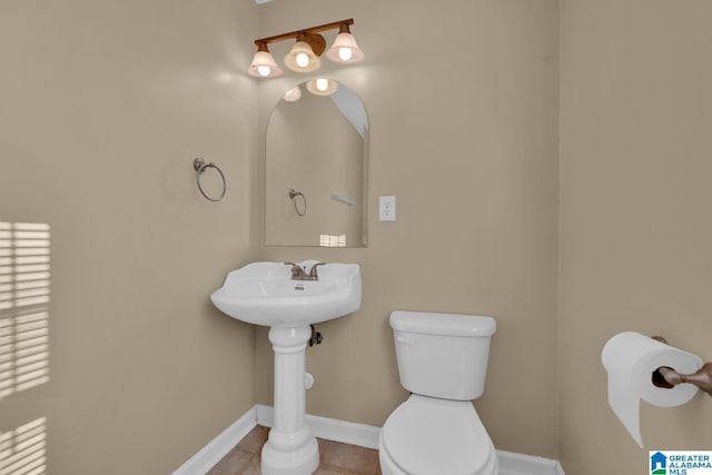 bathroom with tile patterned flooring and toilet