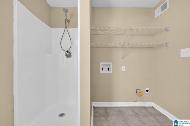 clothes washing area featuring hookup for an electric dryer, hookup for a washing machine, and light tile patterned floors