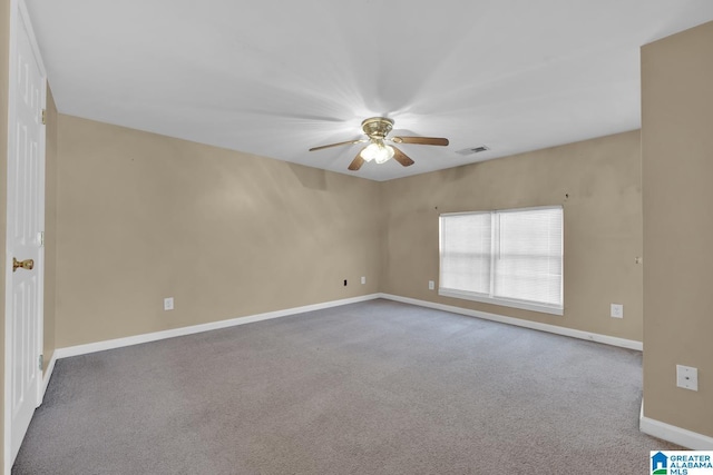 carpeted spare room featuring ceiling fan