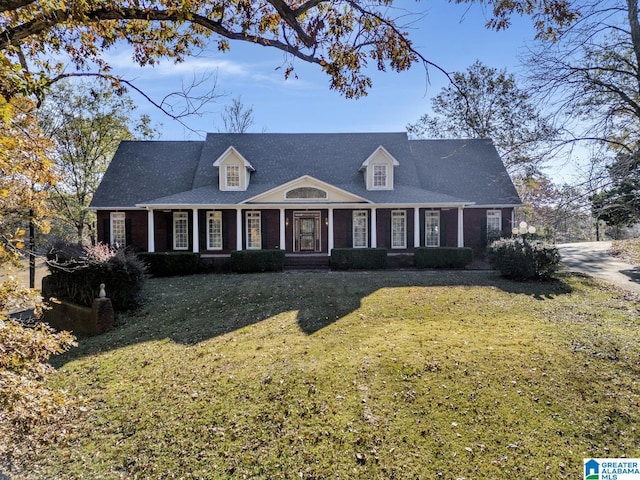 cape cod-style house featuring a front lawn